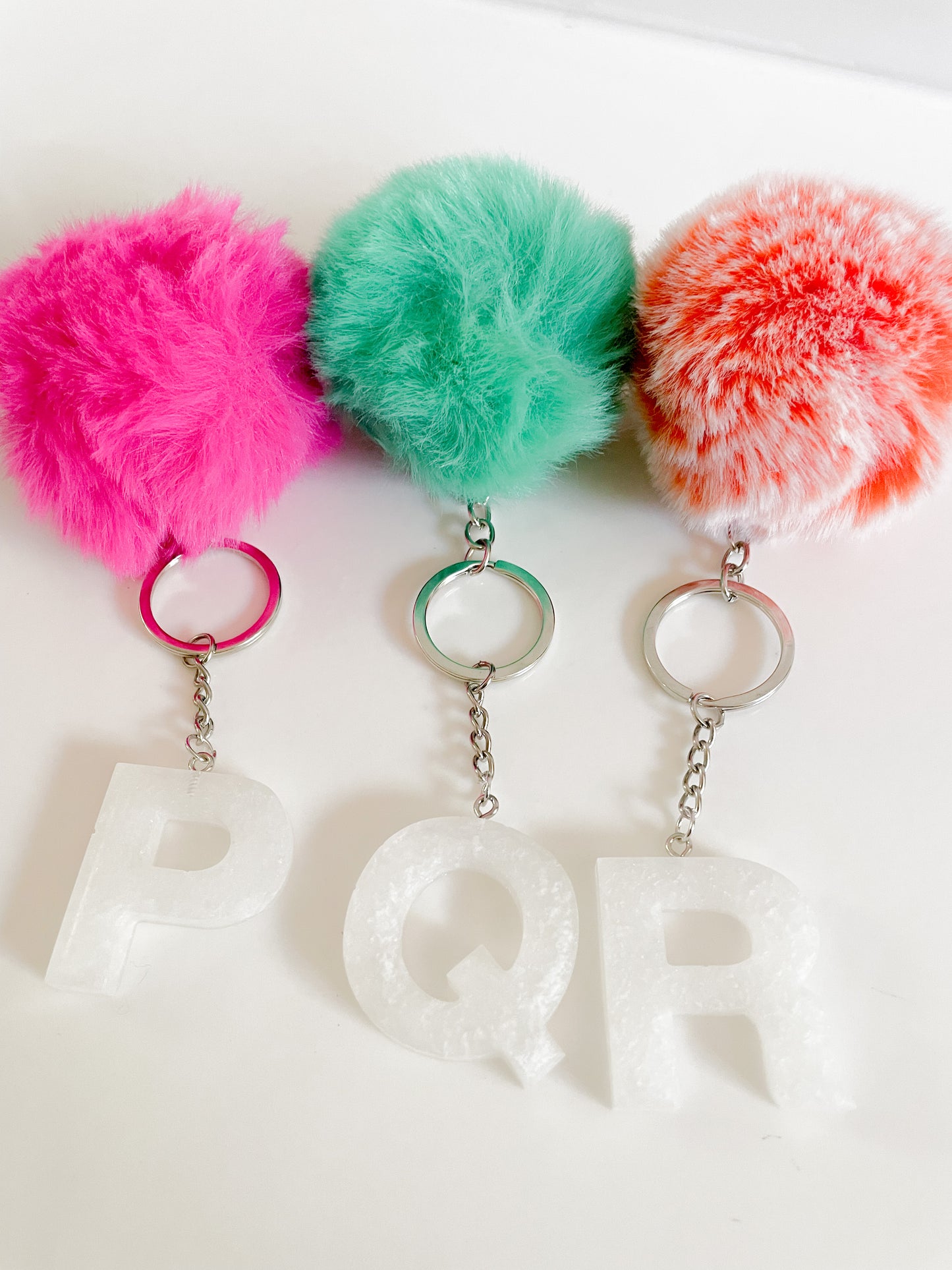 White initial silver keychain w/Pom