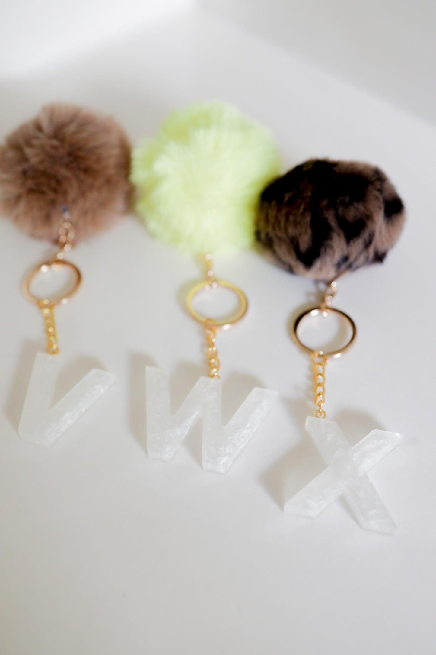 White initial Gold keychain w/pom