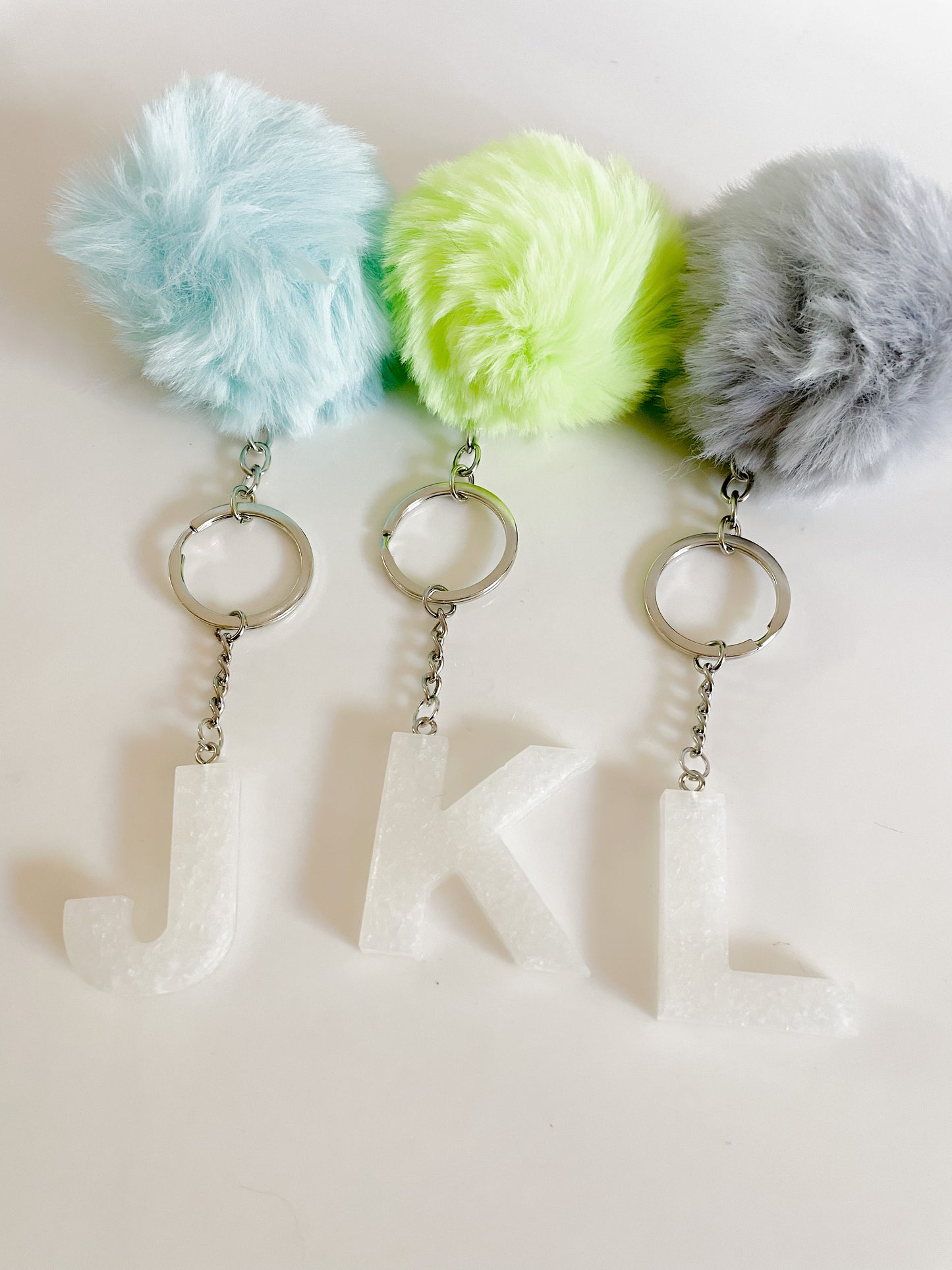 White initial silver keychain w/Pom
