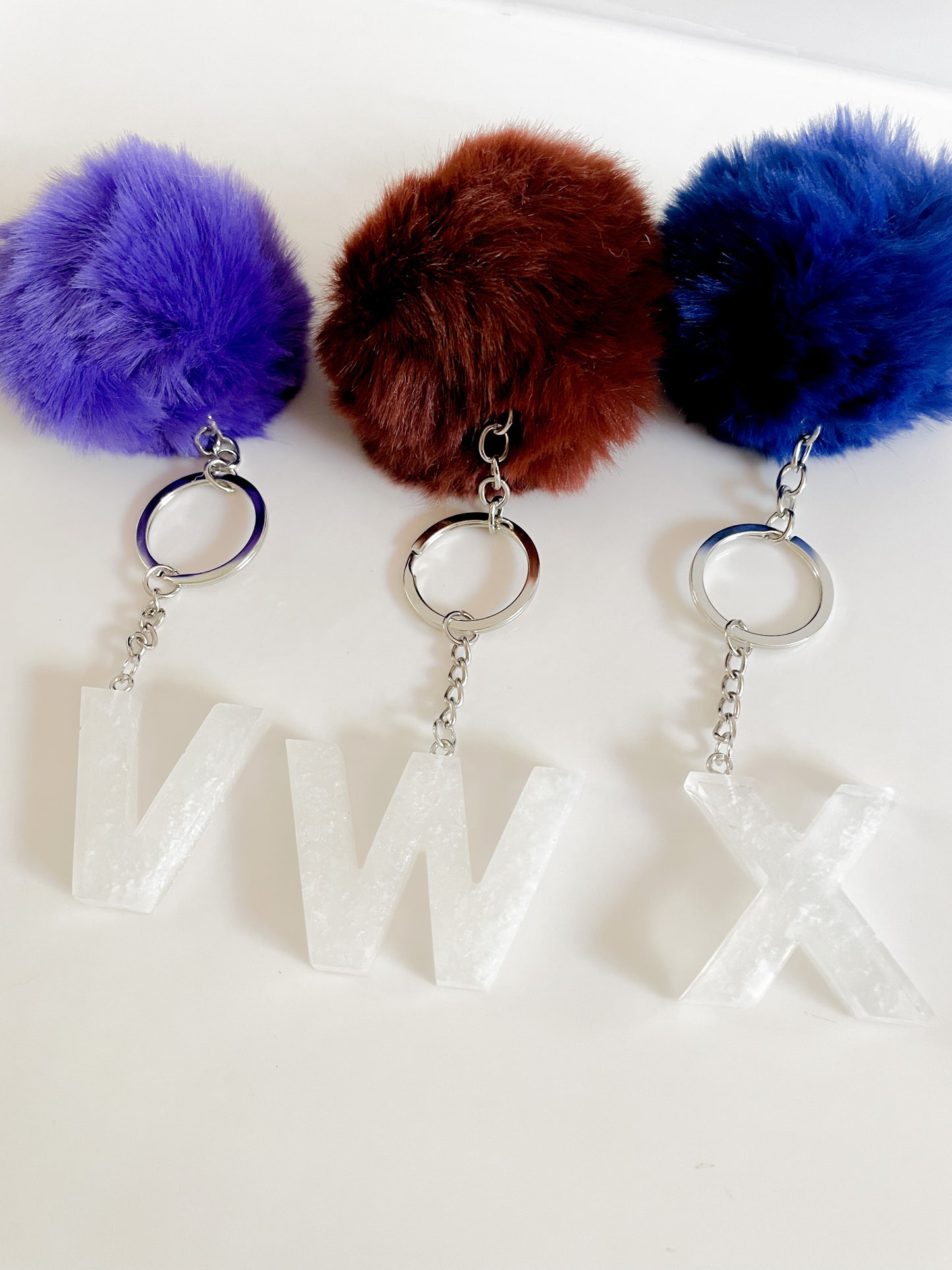 White initial silver keychain w/Pom