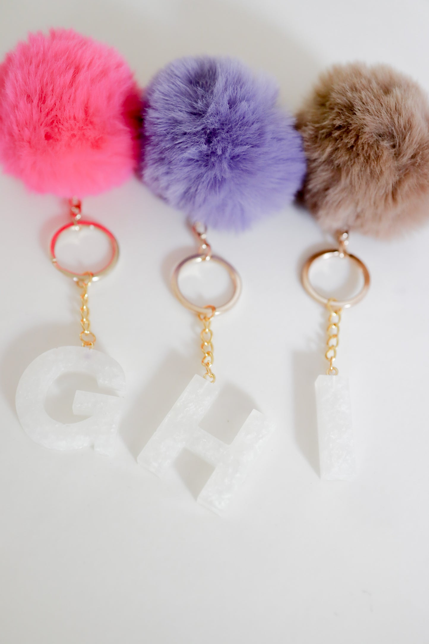 White initial Gold keychain w/pom