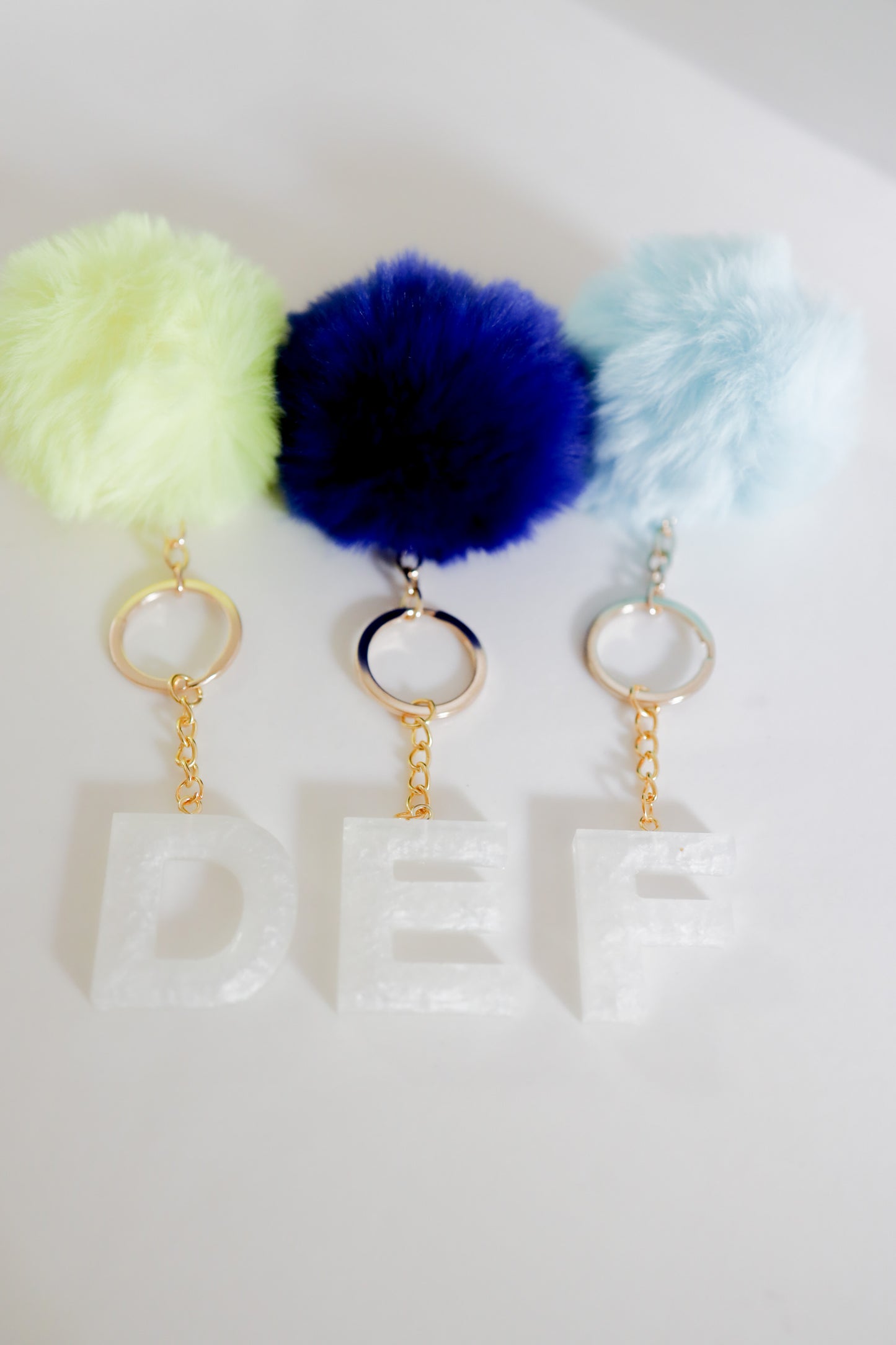 White initial Gold keychain w/pom