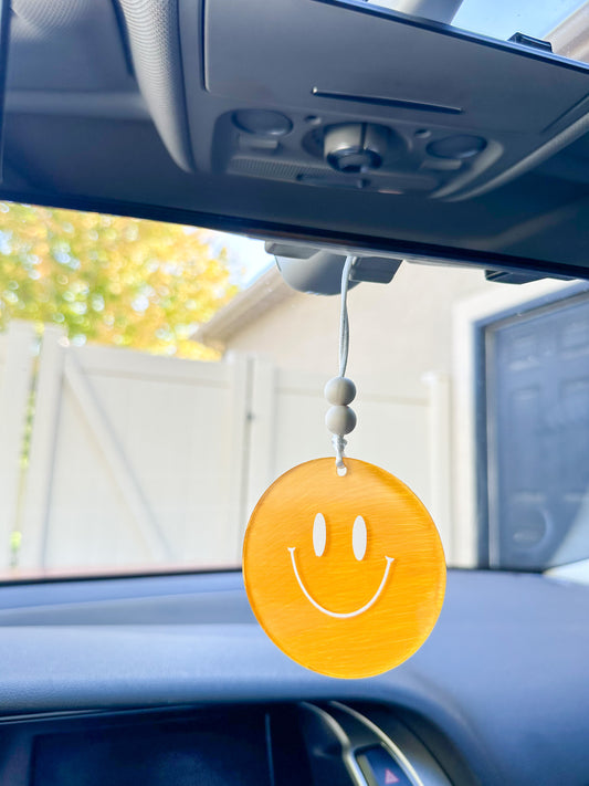 Yellow smiley face car hanger