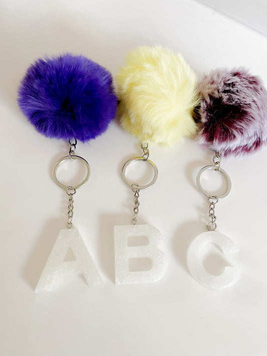 White initial silver keychain w/Pom